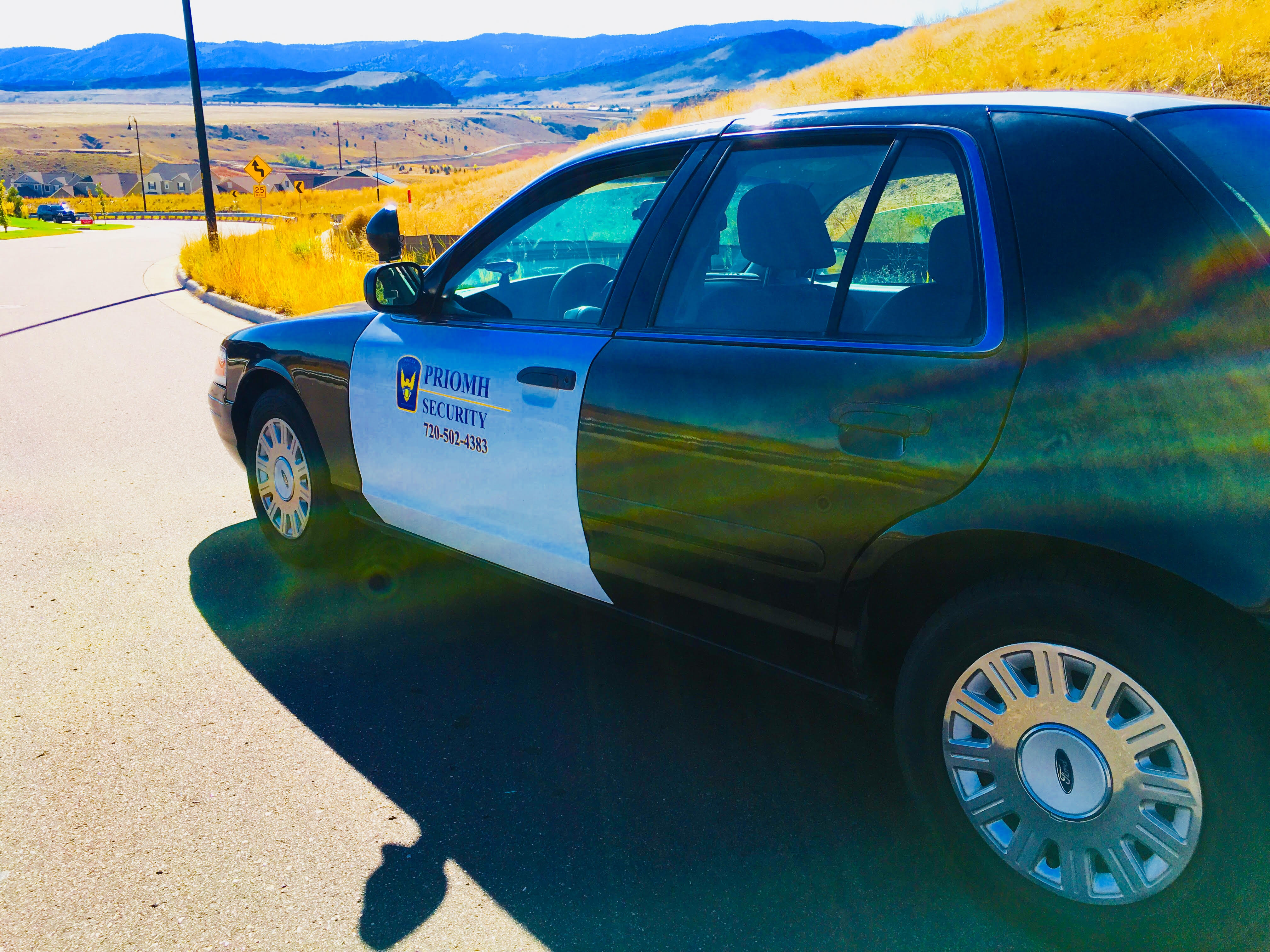 Priomh Security Crown Victoria patrol vehicle with Colorado mountains in the background